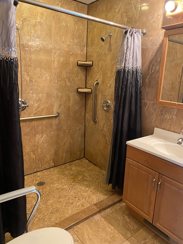 bathroom featuring vanity, toilet, and curtained shower