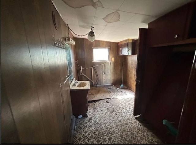 bathroom with vanity and wooden walls