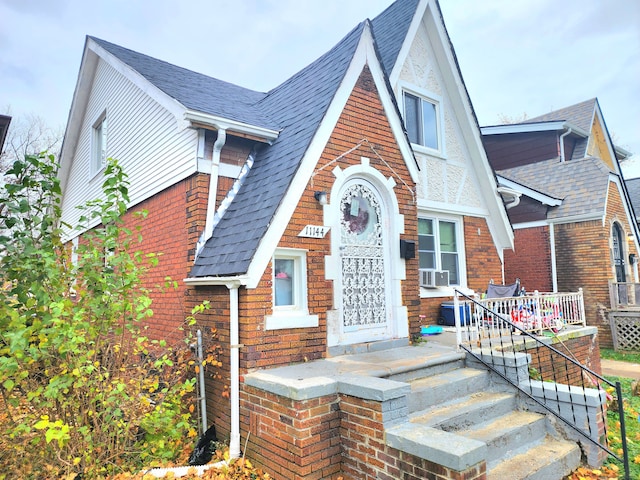 english style home featuring cooling unit