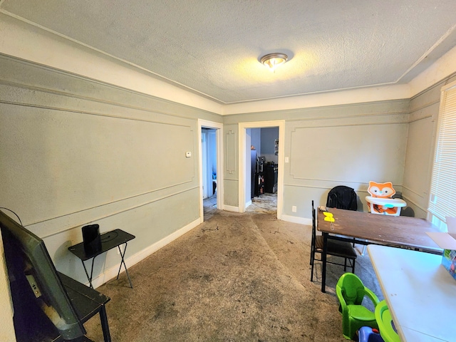 carpeted office featuring a textured ceiling