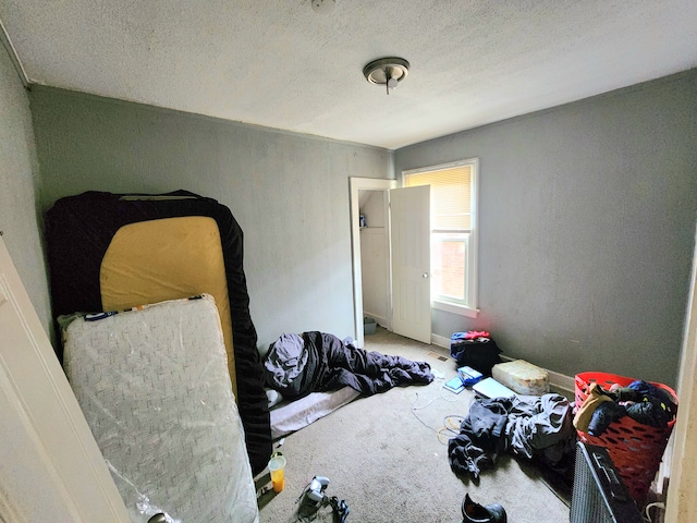 carpeted bedroom featuring a textured ceiling