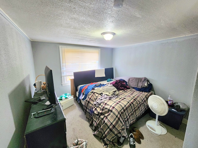 bedroom with light colored carpet and a textured ceiling