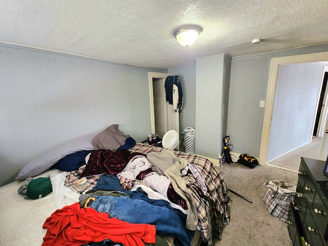 bedroom with carpet and a textured ceiling