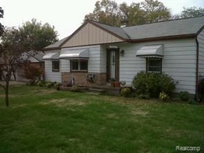 rear view of house with a yard