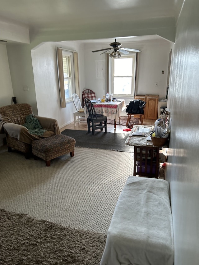 living area with carpet flooring and ceiling fan