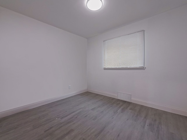 unfurnished room with hardwood / wood-style floors