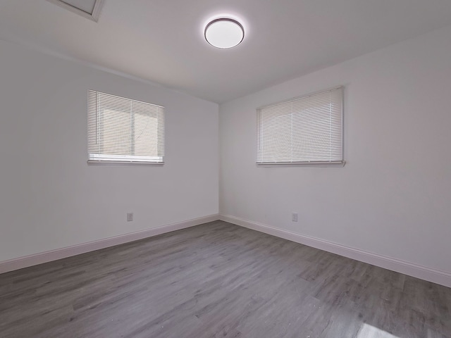 empty room with hardwood / wood-style flooring