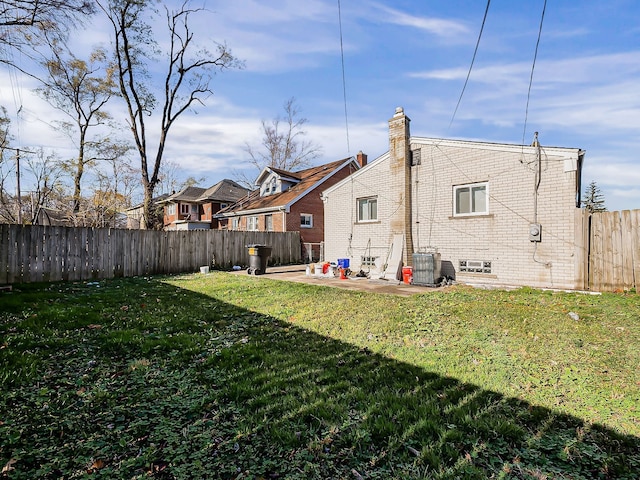 back of house with a yard, a patio, and central AC