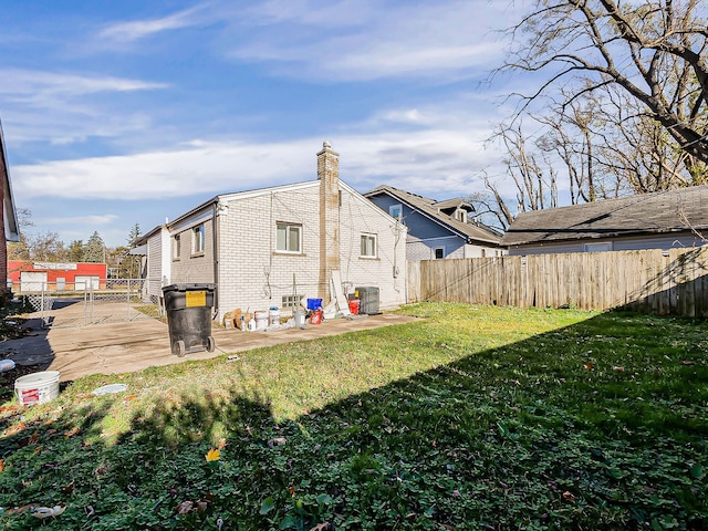 view of home's exterior featuring a yard, central AC, and a patio area