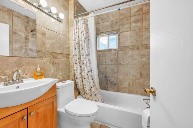 full bathroom featuring shower / tub combo, backsplash, vanity, tile walls, and toilet