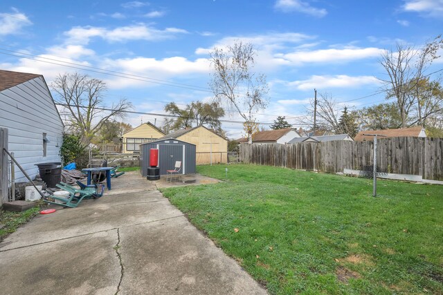 view of yard featuring a storage unit and a patio area