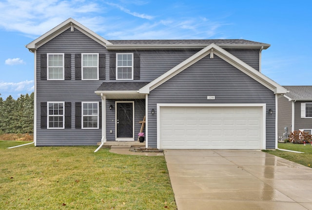 view of front of home featuring a garage and a front lawn