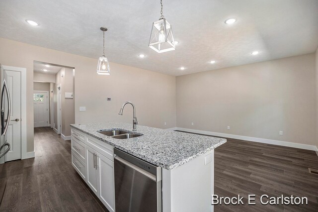 kitchen featuring pendant lighting, dishwasher, sink, dark hardwood / wood-style floors, and white cabinetry