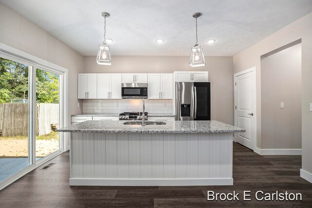 kitchen with dark hardwood / wood-style flooring, white cabinetry, and stainless steel appliances