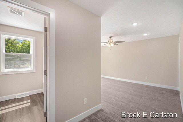 unfurnished room featuring carpet flooring, ceiling fan, and a textured ceiling