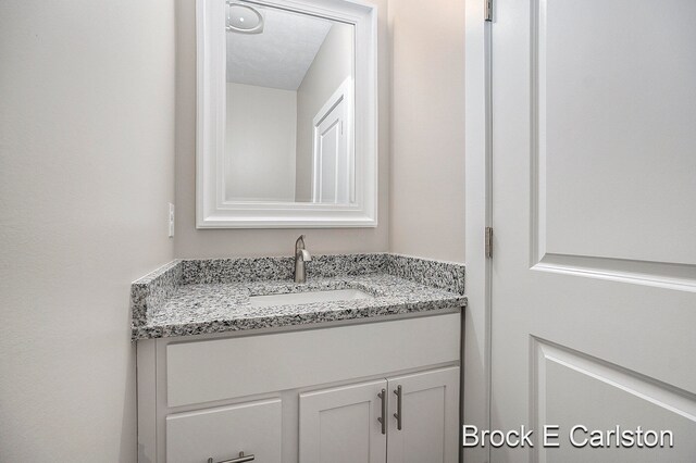 bathroom featuring vanity and a textured ceiling