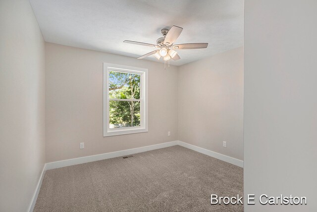 empty room featuring ceiling fan and carpet floors