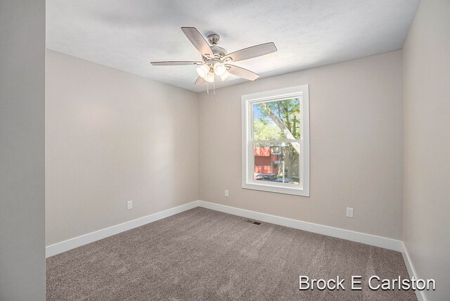 carpeted empty room with ceiling fan