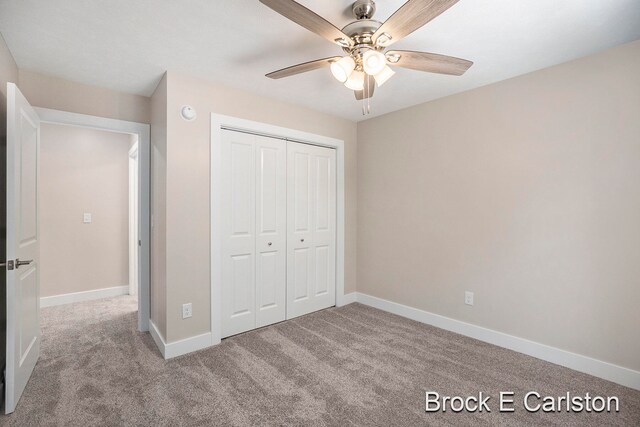 unfurnished bedroom featuring ceiling fan, light carpet, and a closet