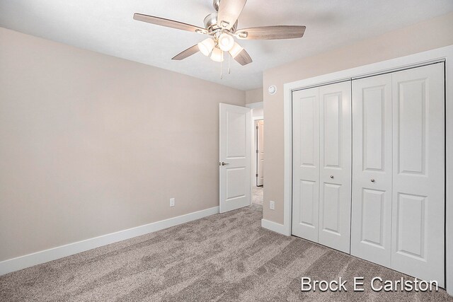 unfurnished bedroom with ceiling fan, light colored carpet, and a closet