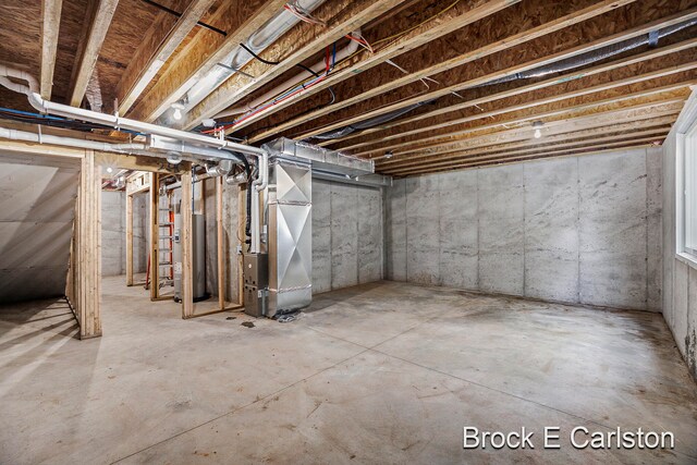 basement with water heater and heating unit