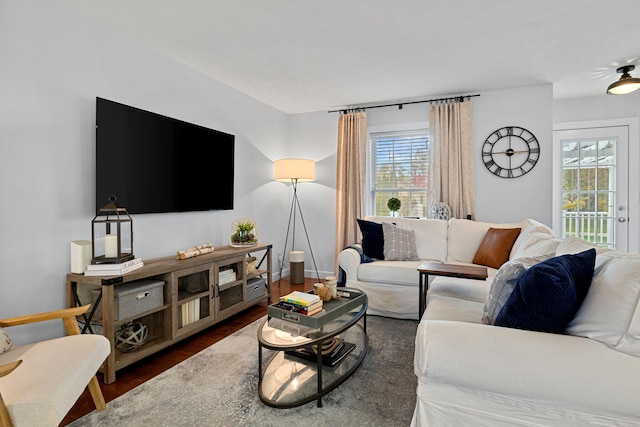 living room with plenty of natural light and dark hardwood / wood-style floors