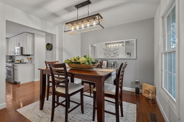 dining area with hardwood / wood-style flooring