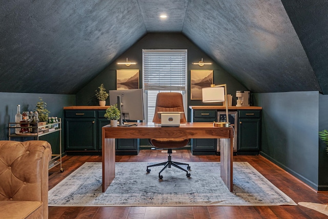 office area featuring a textured ceiling, dark wood-type flooring, and lofted ceiling