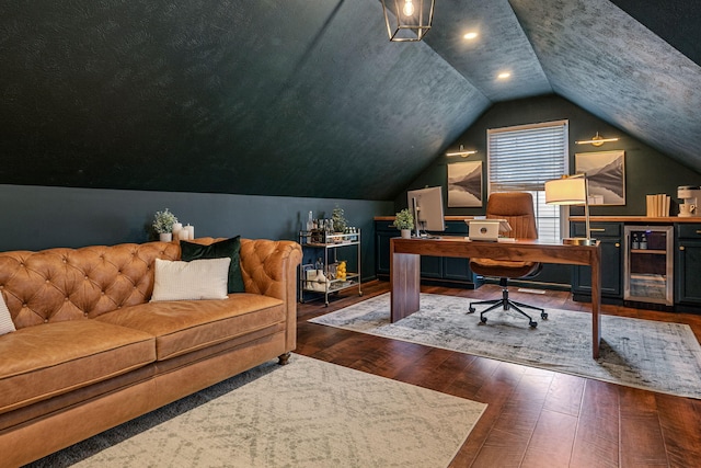 office with dark hardwood / wood-style floors, vaulted ceiling, and beverage cooler