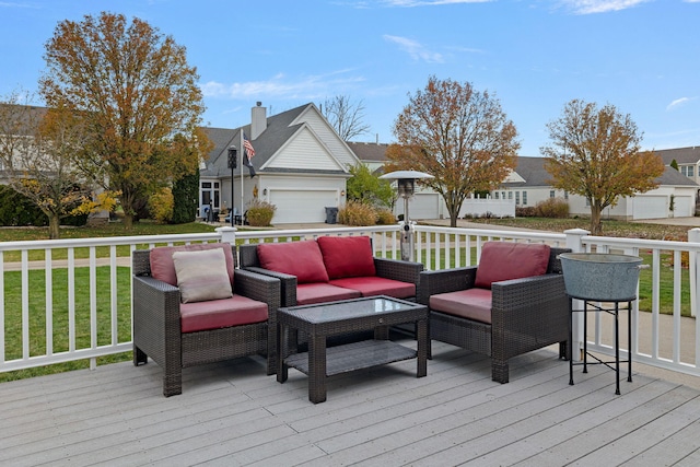 wooden deck with a garage and a lawn