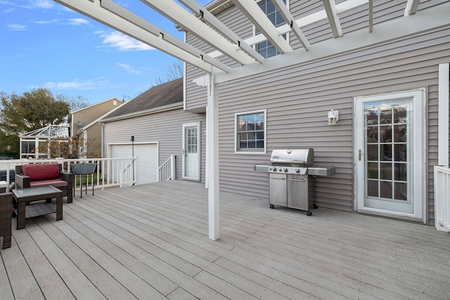 wooden terrace featuring a pergola, area for grilling, and a garage