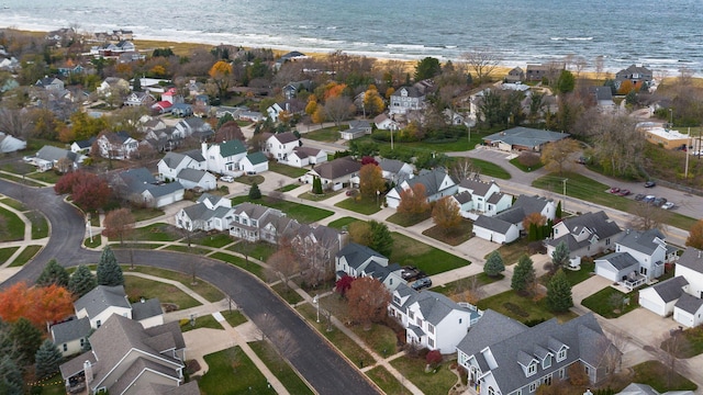 drone / aerial view with a beach view and a water view