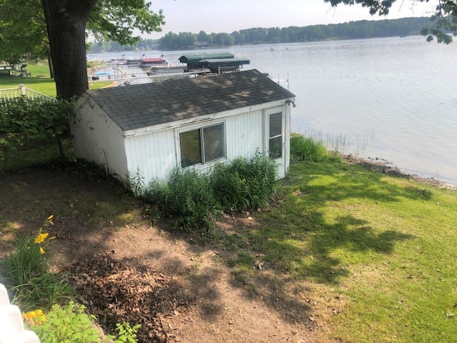 14402 90th Ave, Mecosta, MI 49332 - view of home's exterior with a water view, a lawn, a shingled roof, and a boat dock