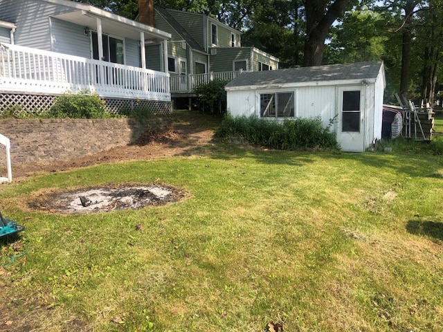14402 90th Ave, Mecosta, MI 49332 - view of green lawn featuring an outdoor structure and a wooden deck