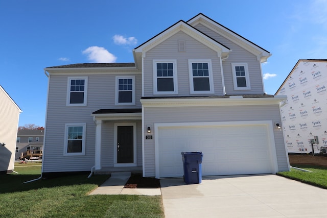 view of front of house with a front yard and a garage