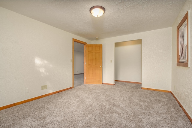 unfurnished bedroom featuring a closet, carpet floors, and a textured ceiling