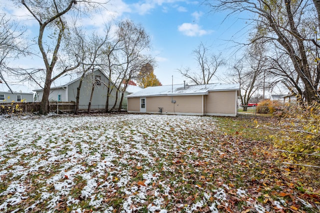 view of snow covered rear of property