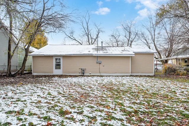 view of snow covered rear of property