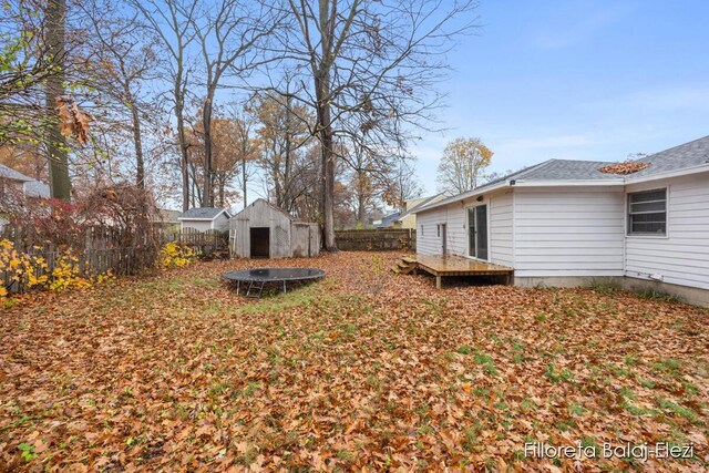 4481 Marshall Ave SE, Grand Rapids, MI 49508 - fenced backyard with a deck and a trampoline