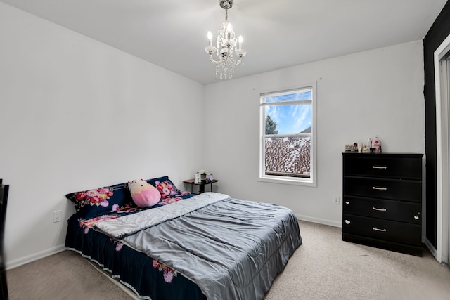 bedroom featuring carpet flooring and an inviting chandelier