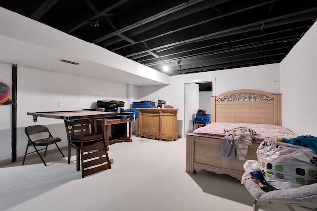 bedroom featuring concrete flooring