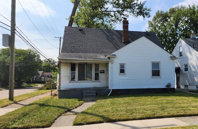 bungalow-style home with a front lawn