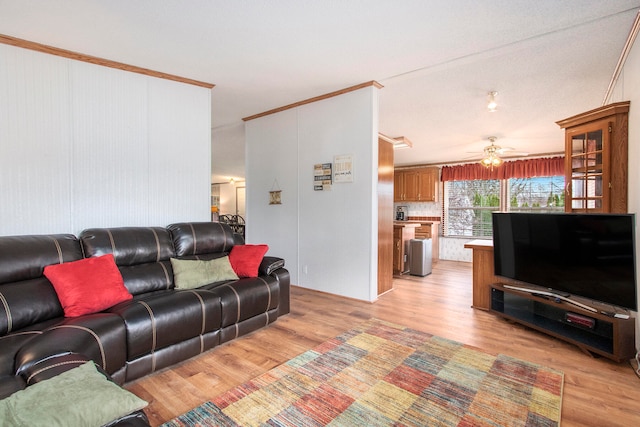 living room featuring light hardwood / wood-style flooring, ceiling fan, and ornamental molding