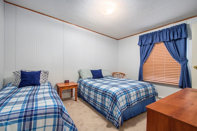 carpeted bedroom with crown molding and a textured ceiling