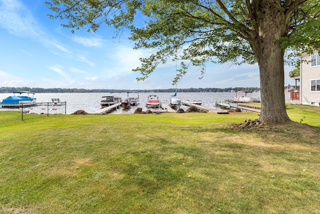 view of yard featuring a boat dock and a water view