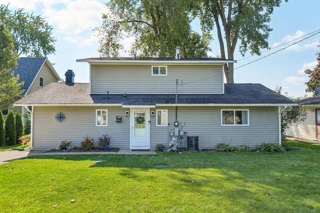 back of house featuring a lawn