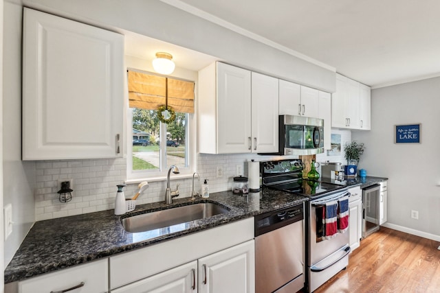 kitchen featuring white cabinetry, sink, and appliances with stainless steel finishes