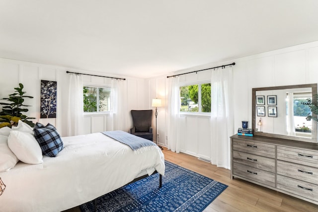 bedroom featuring light hardwood / wood-style floors and multiple windows