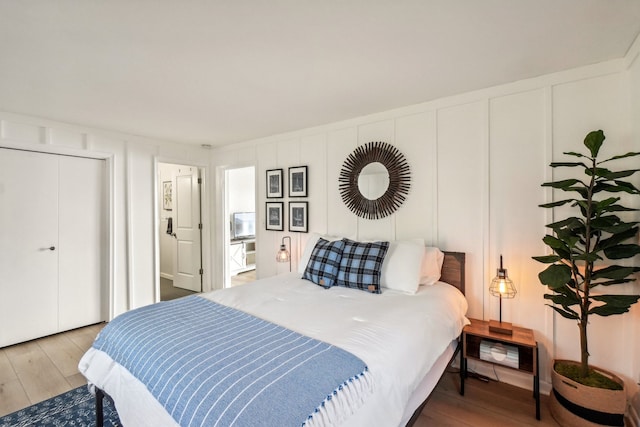 bedroom with hardwood / wood-style floors and a closet