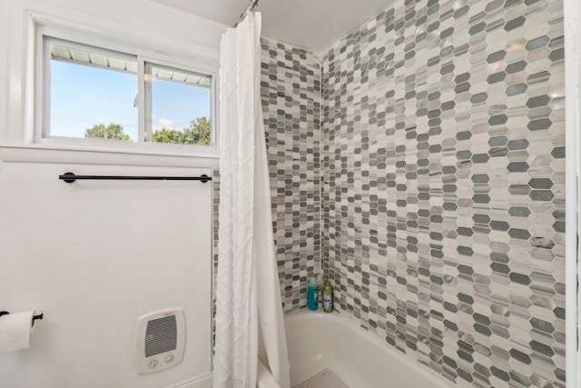 bathroom with shower / bath combo and heating unit